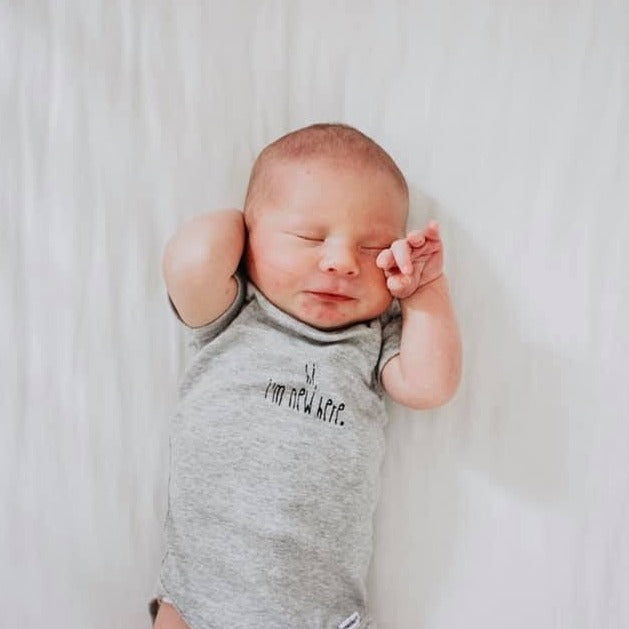 "Hi, I'm New Here" onesie