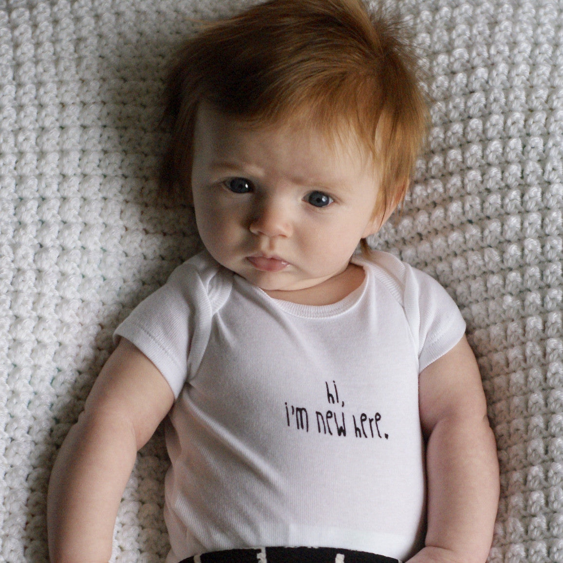 "Hi, I'm New Here" onesie