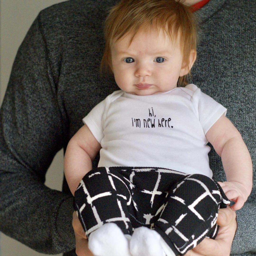 "Hi, I'm New Here" onesie